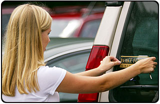 Sarah Butler '07, from Columbus, GA, puts a Wake Forest decal on the back of her car.