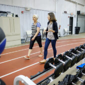 Wake Forest Health and Exercise Science professor Kristen Beavers works with study participant Kaye Brandon at the Clinical Research Center, on the campus of Wake Forest University, Friday, January 17, 2020. The study is looking at whether wearing a weighted vest will prevent bone density loss among older adults who are losing weight for health reasons.