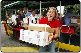 A freshman gets off the Information Systems trolley with her new ThinkPad