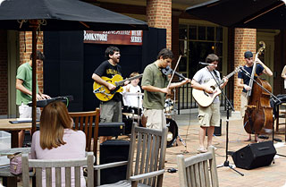 The band Carrotandstick plays in front of the bookstore.