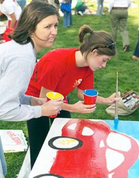Wake Forest student Carolyn Gabbert paints a desk during the 2004 D.E.S.K. project.