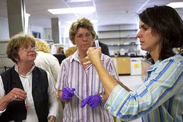 Chemistry professor Rebecca Alexander, right, is using a National Science Foundation grant to fund a workshop on "The Science Behind Biotechnology" for science teachers from Forsyth County. She helps Philo Middle School teachers Susan Crump (in vest) and Jennifer Sasser extract DNA from a strawberry.