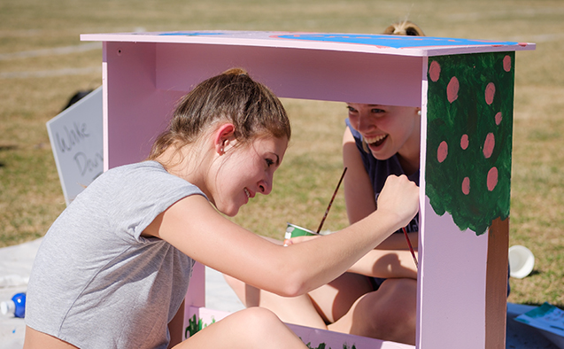 Wake Forest students paint desks for local elementary school students at the annual volunteer service project DESK, on Poteat Field on Wednesday, April 10, 2019.
