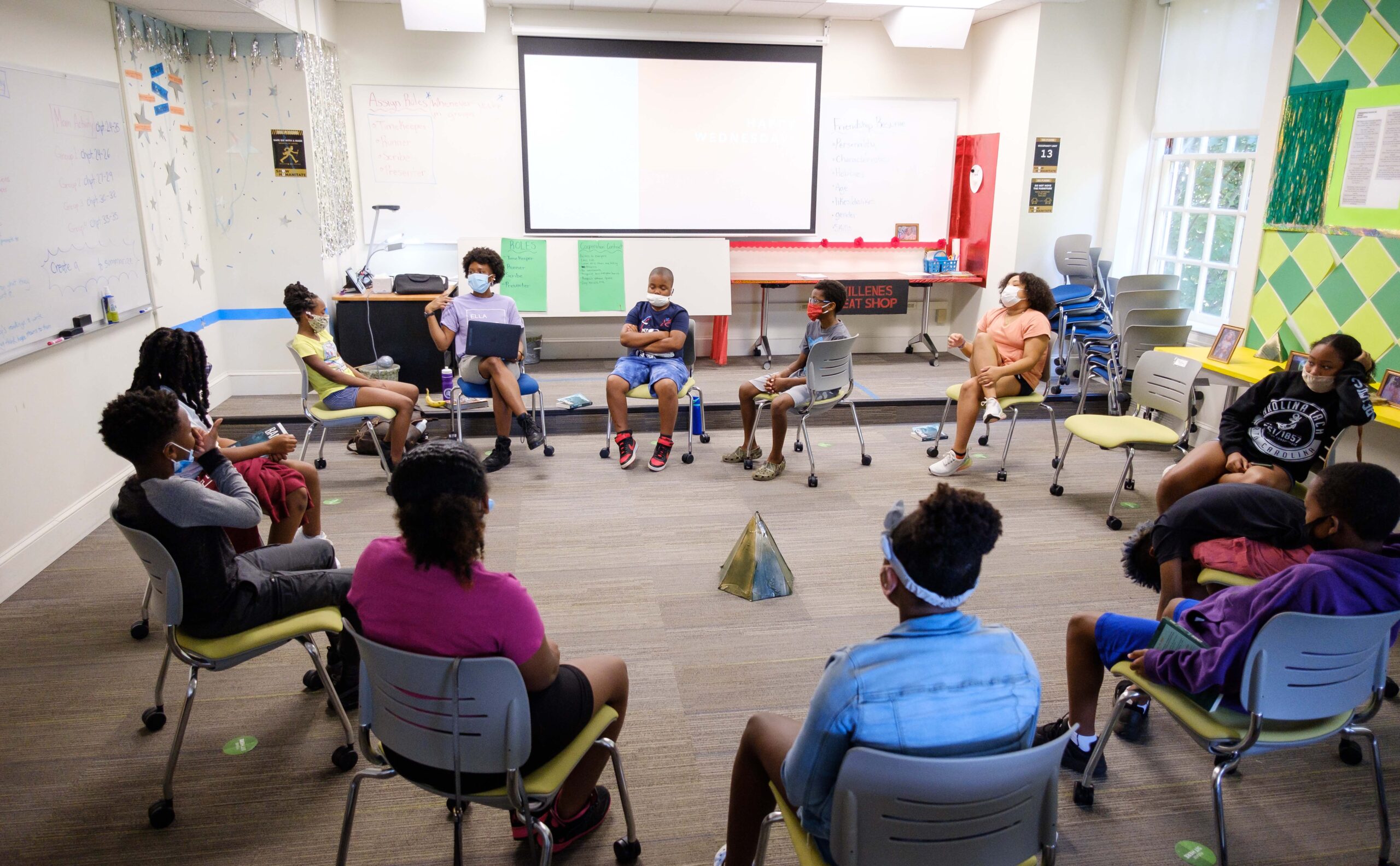 Freedom School scholars listen as teacher Sierra DeVeaux, a Wake Forest rising senior and sociology major, reads to them. 