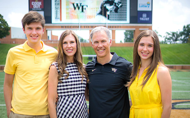 Coach Clawson standing with is family