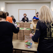 Volunteers pack meals