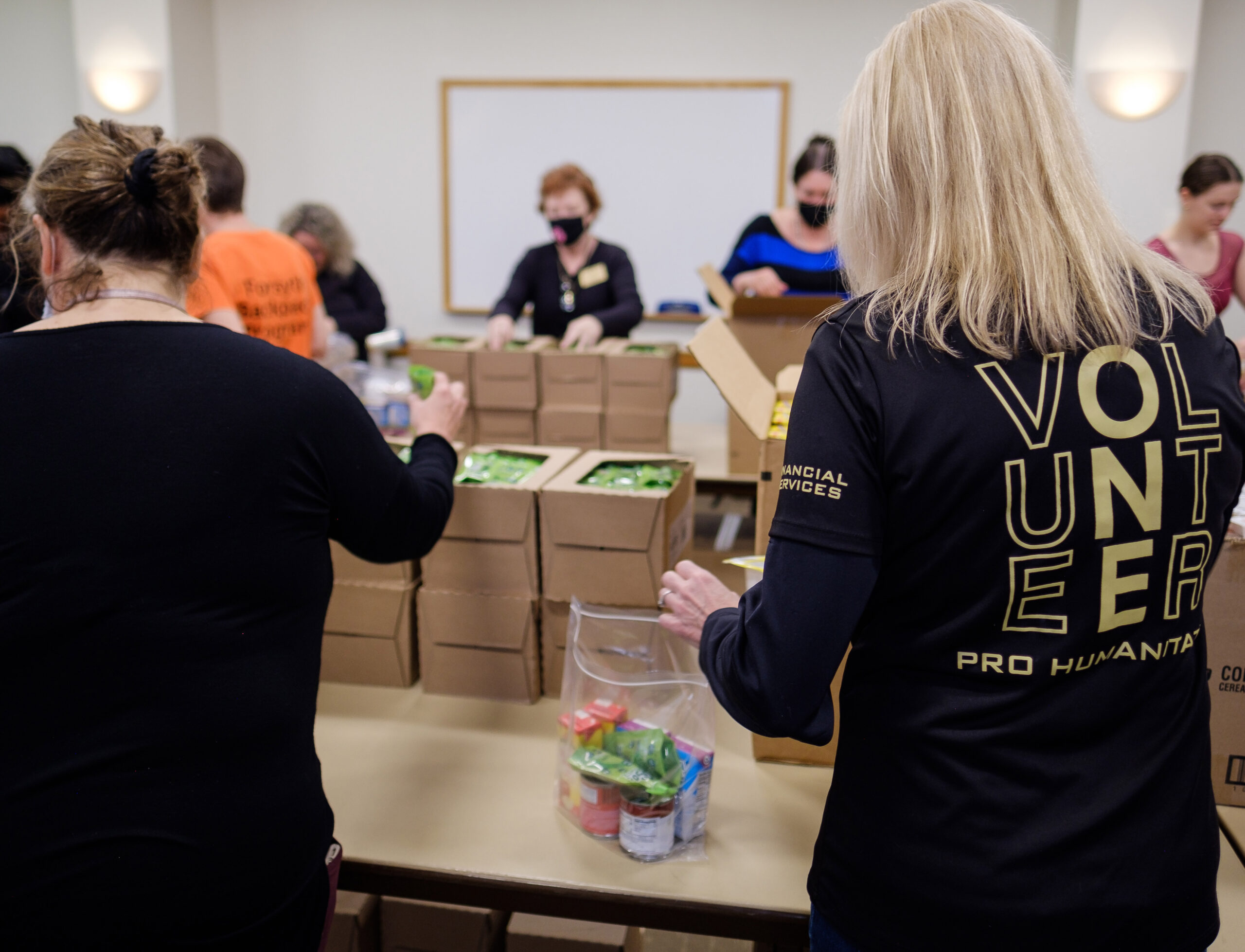 Volunteers pack meals