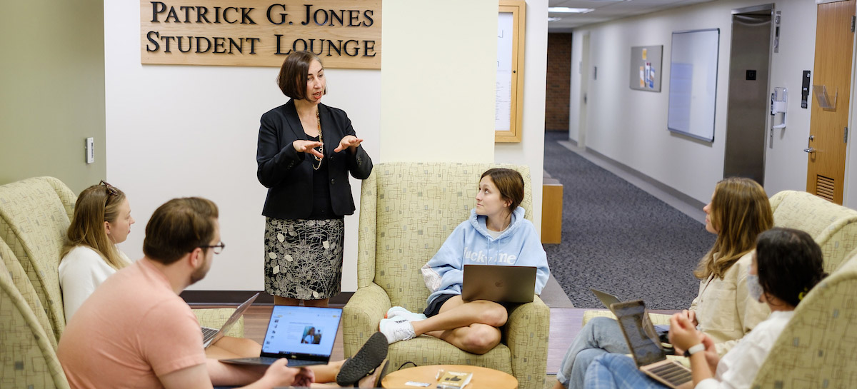 Professor Ana-Maria Gonzalez Wahl talks with members of the class about their family work histories. 
 