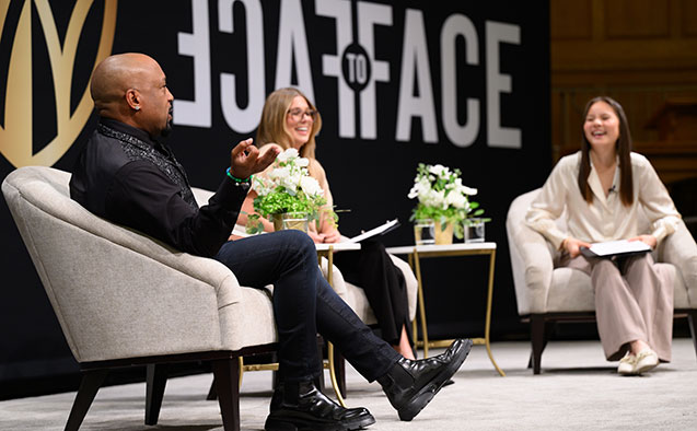 Daymond John talks with student moderators at the Face to Face event in Wait Chapel.