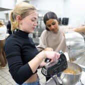 WFU students mix stuffing for Thanksgiving dinners for Turkeypalooza.