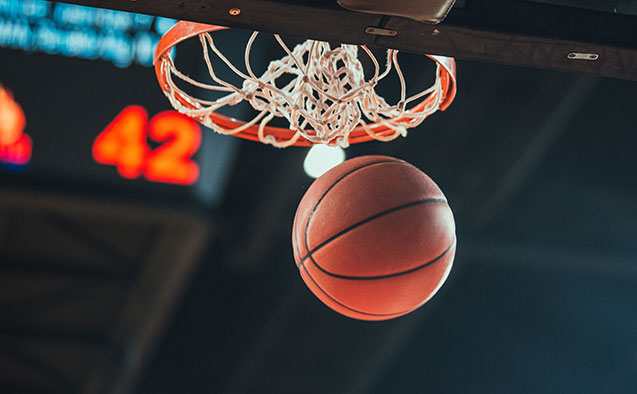 Basketball going through a hoop during a game