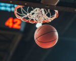 Basketball going through a hoop during a game