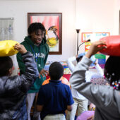 Children in class learning science with WFU theatre students.