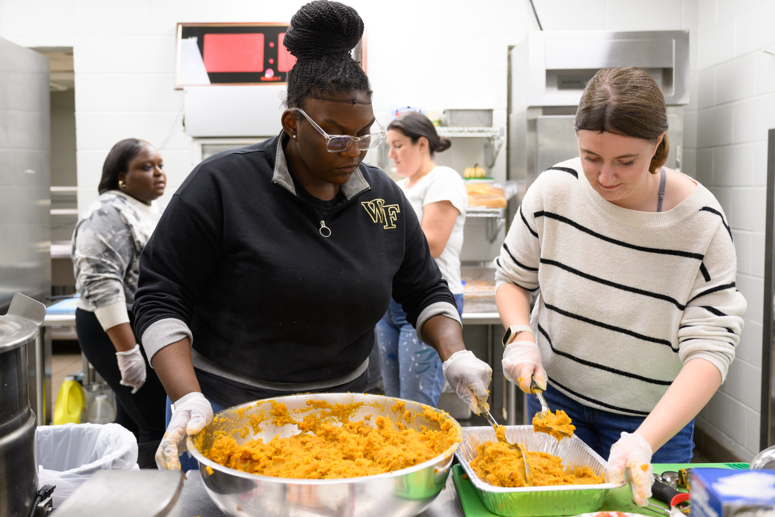 Wake Forest University students and staff prep, cook, and package Thanksgiving meals from scratch in the kitchen at the First Assembly Christian School on Tuesday, November 15, 2022 as part of Turkeypalooza.