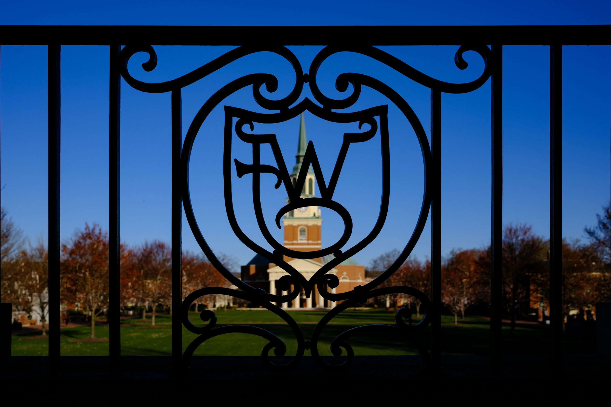 Wait Chapel is framed by ironwork on the Wake Forest University campus on a cool spring morning,  Tuesday, March 12, 2024.