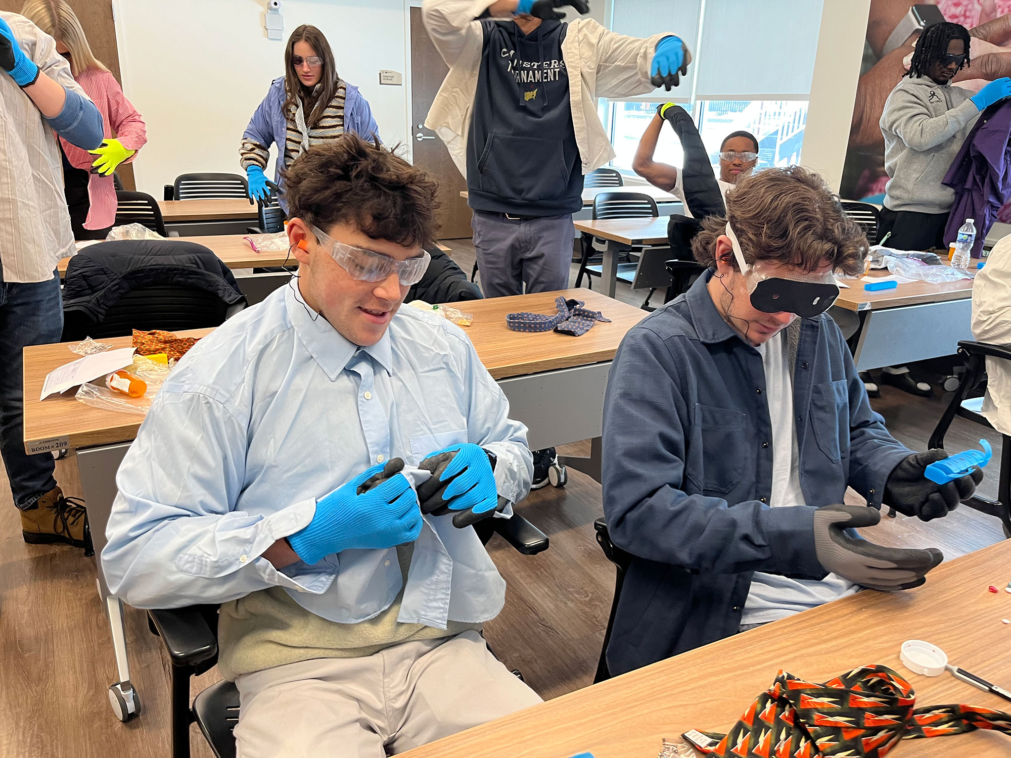 To prepare for volunteering, students underwent “empathy training.” They donned gloves and blurry glasses to mimic symptoms of dementia and aging.