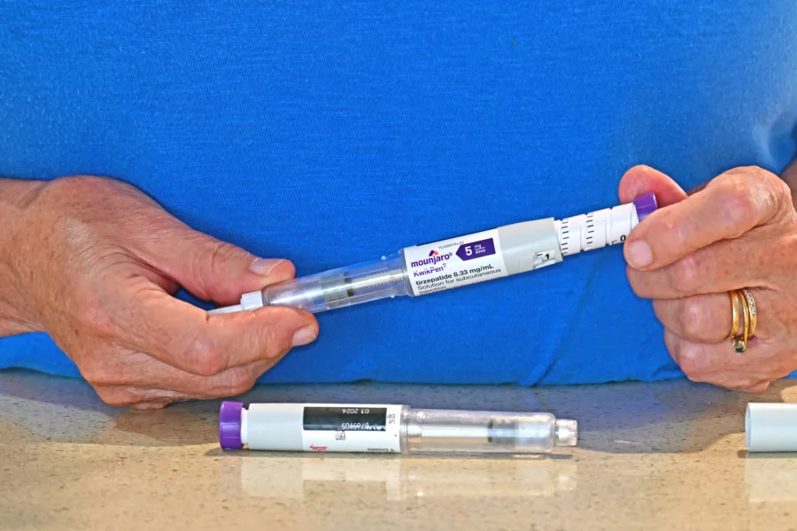 Lake Macquarie New South Wales Australia – April 25, 2025 Person adjusting a Mounjaro pen ready for injecting