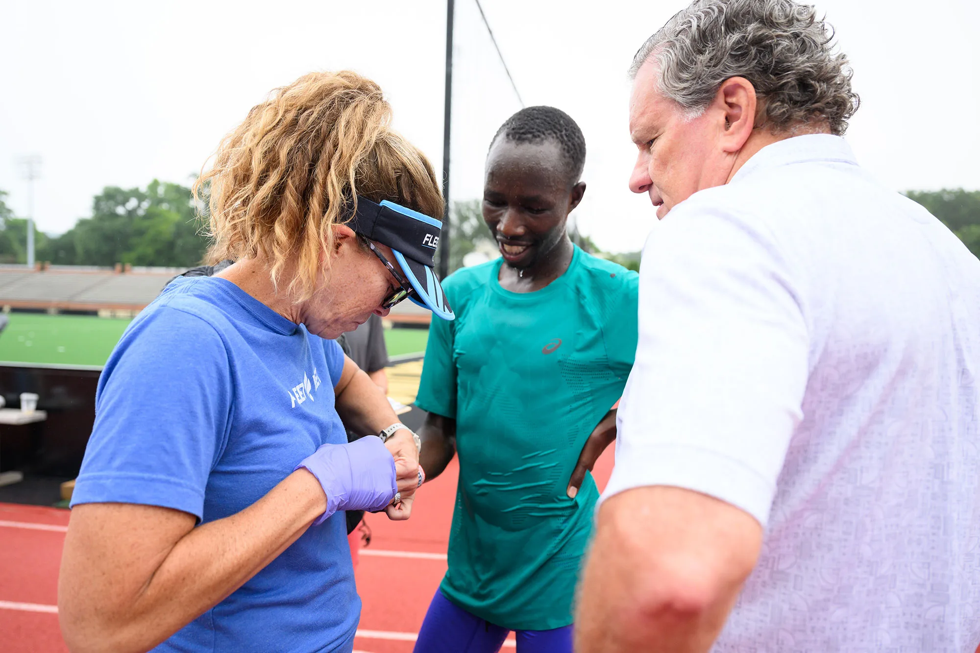 Emily Davis, local Fleet Feet owner, learns how to conduct lactate threshold testing with marathoner John Korir and Wake Forest researcher Peter Brubaker.