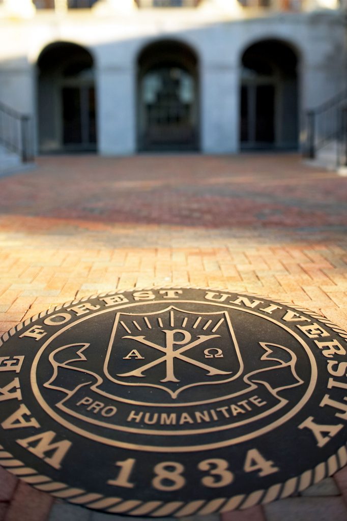 The Seal of Wake Forest University inset in the new brick walkway in front of Reynolda Hall on the Quad.