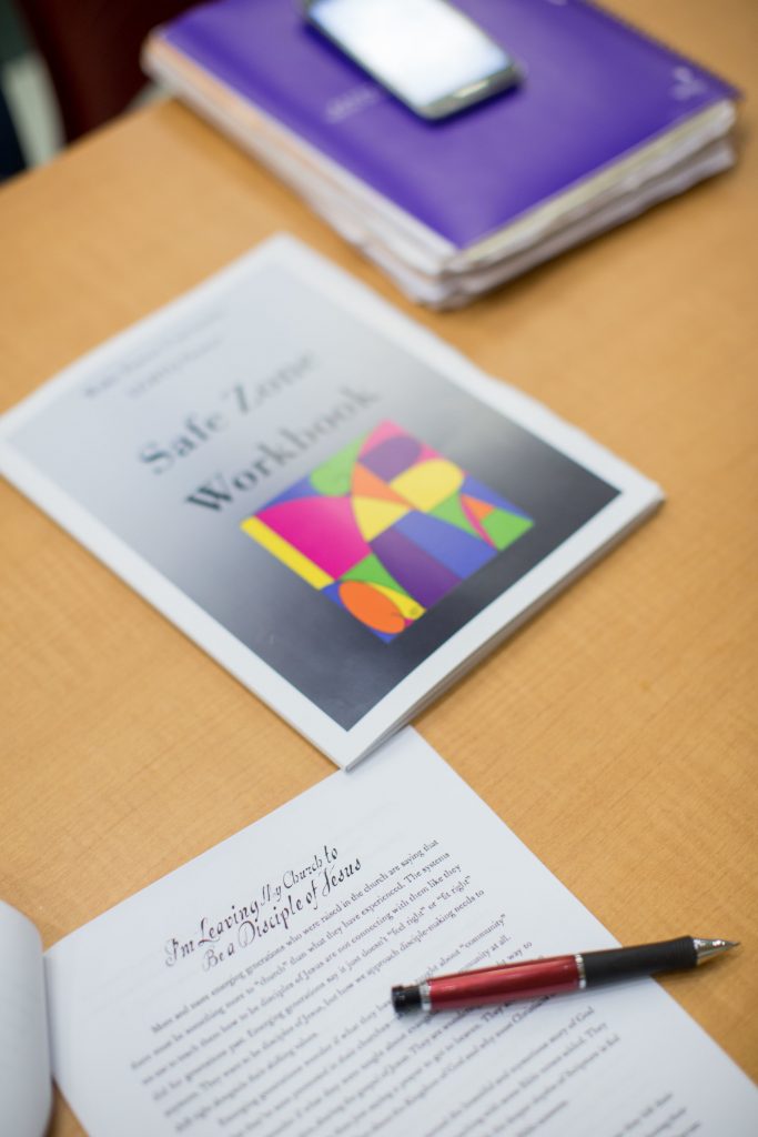 School of Divinity students review the Safe Zone Workbook - related to LGBTQ inclusion - handed out from the LGBTQ Center on campus