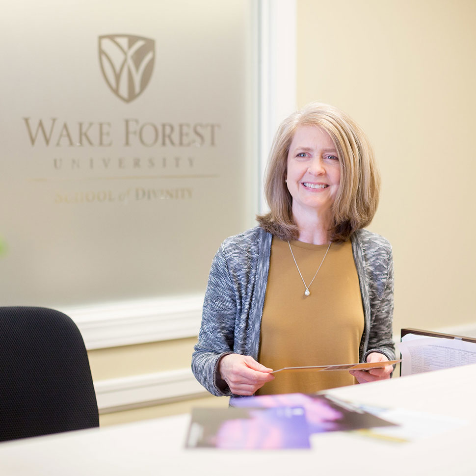 School of Divinity admissions staff welcome a visitor to the Office of Admissions in Wingate Hall