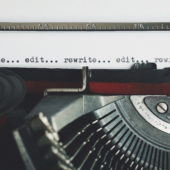 typewriter with rewrite and edit on paper