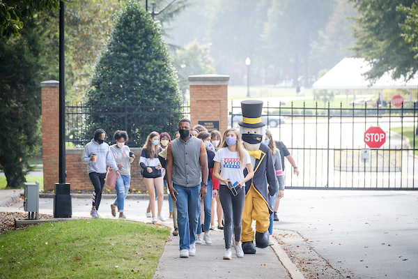 Wake Forest students gather and march to an early voting site across the street from campus on Thursday, October 15, 2020. The Demon Deacon mascot joins the march.