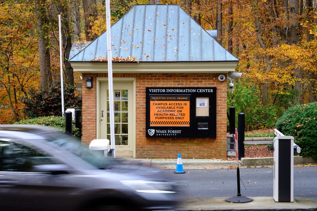 The gatehouse at the Reynolda Road entrance to Wake Forest shows the current Operating Status Orange level as cars enter, on the campus of Wake Forest University, Tuesday, November 10, 2020.