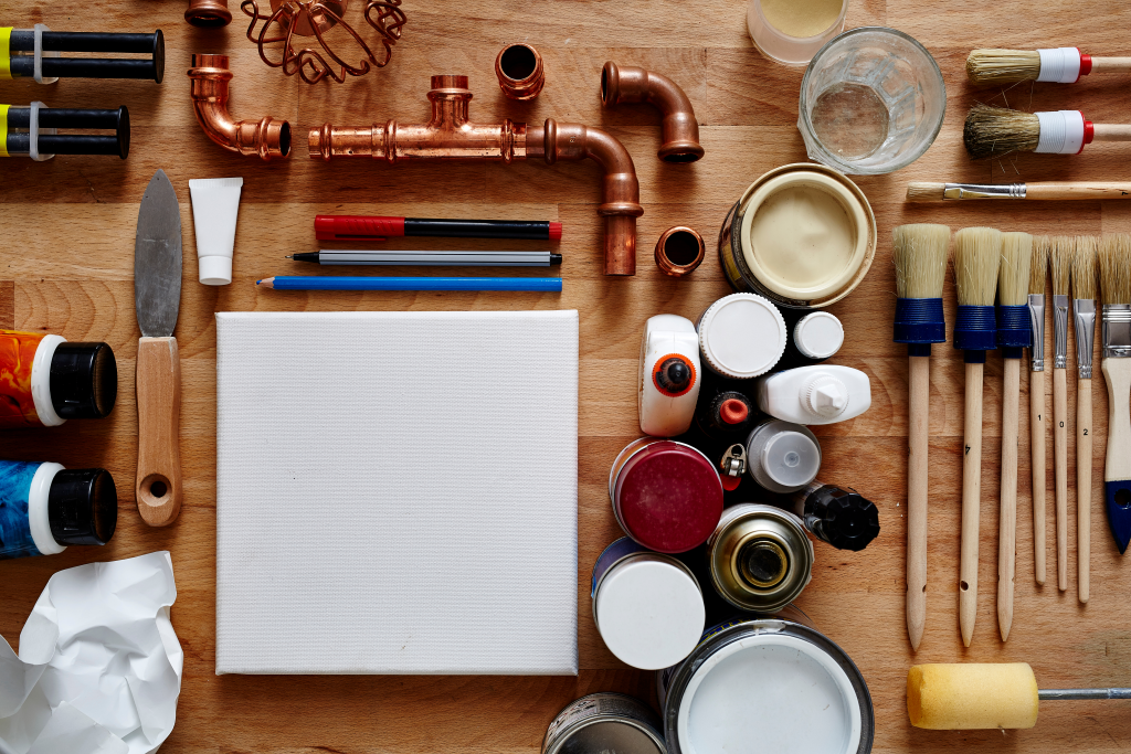 image of a blank canvas with brushes, paint, and supplies