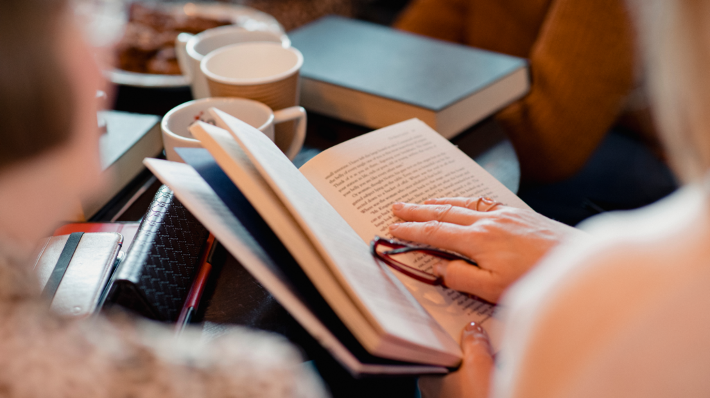 decorative close up of hands of a group of women reading books