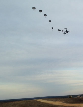 Soldiers parachuting out of a plane