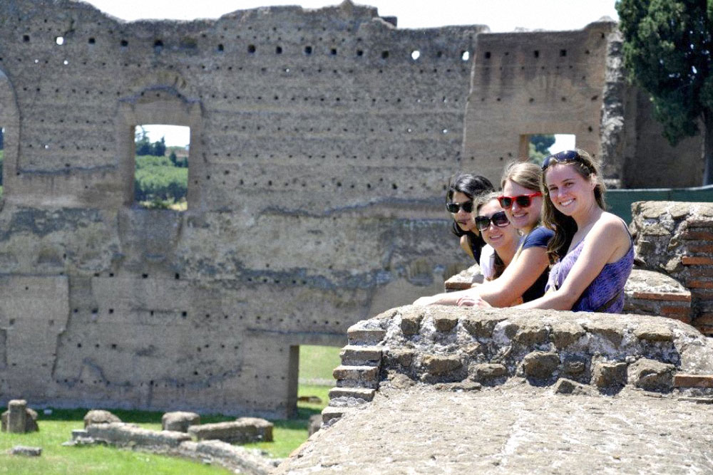 students standing in front of ruins