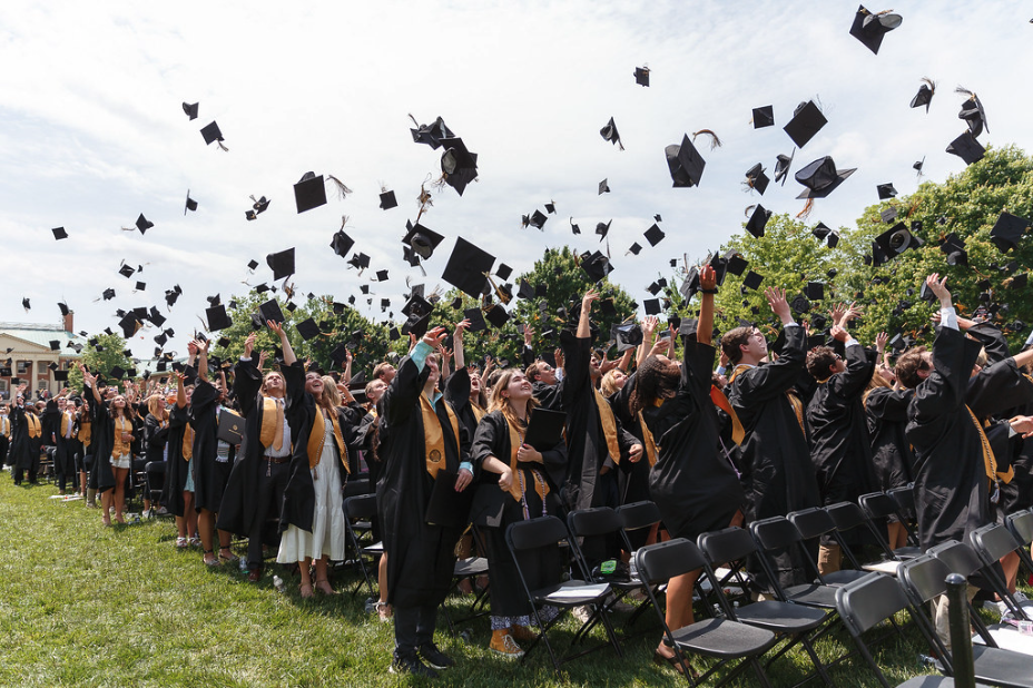 students throwing graduation caps