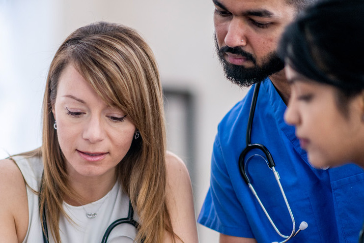 Team of clinical researchers examining a case