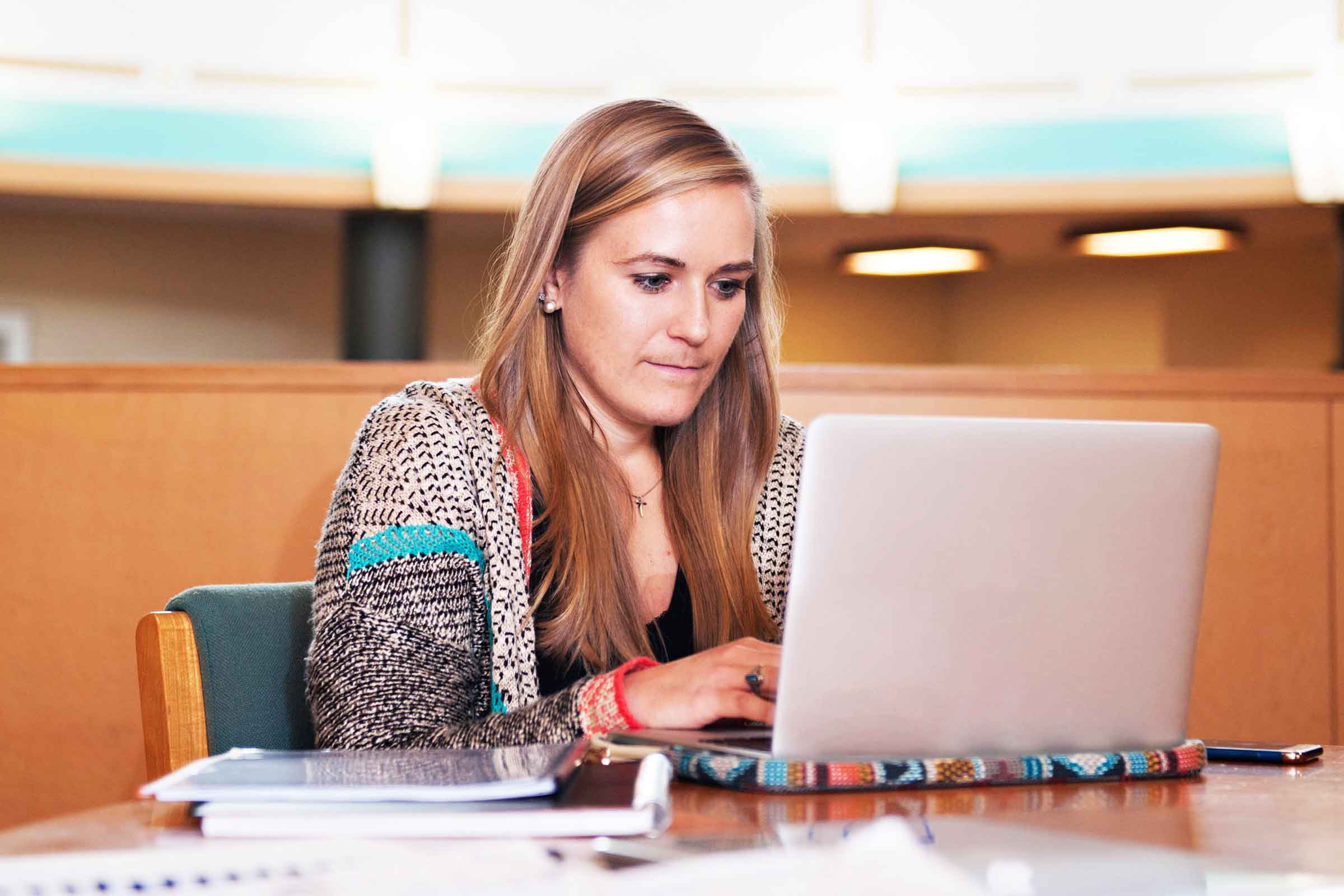 A student working on a laptop computer as a part of Wake Forest Law's Master of Studies in Law