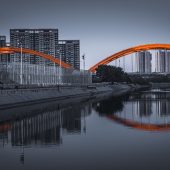 Bridge against black and white cityscape
