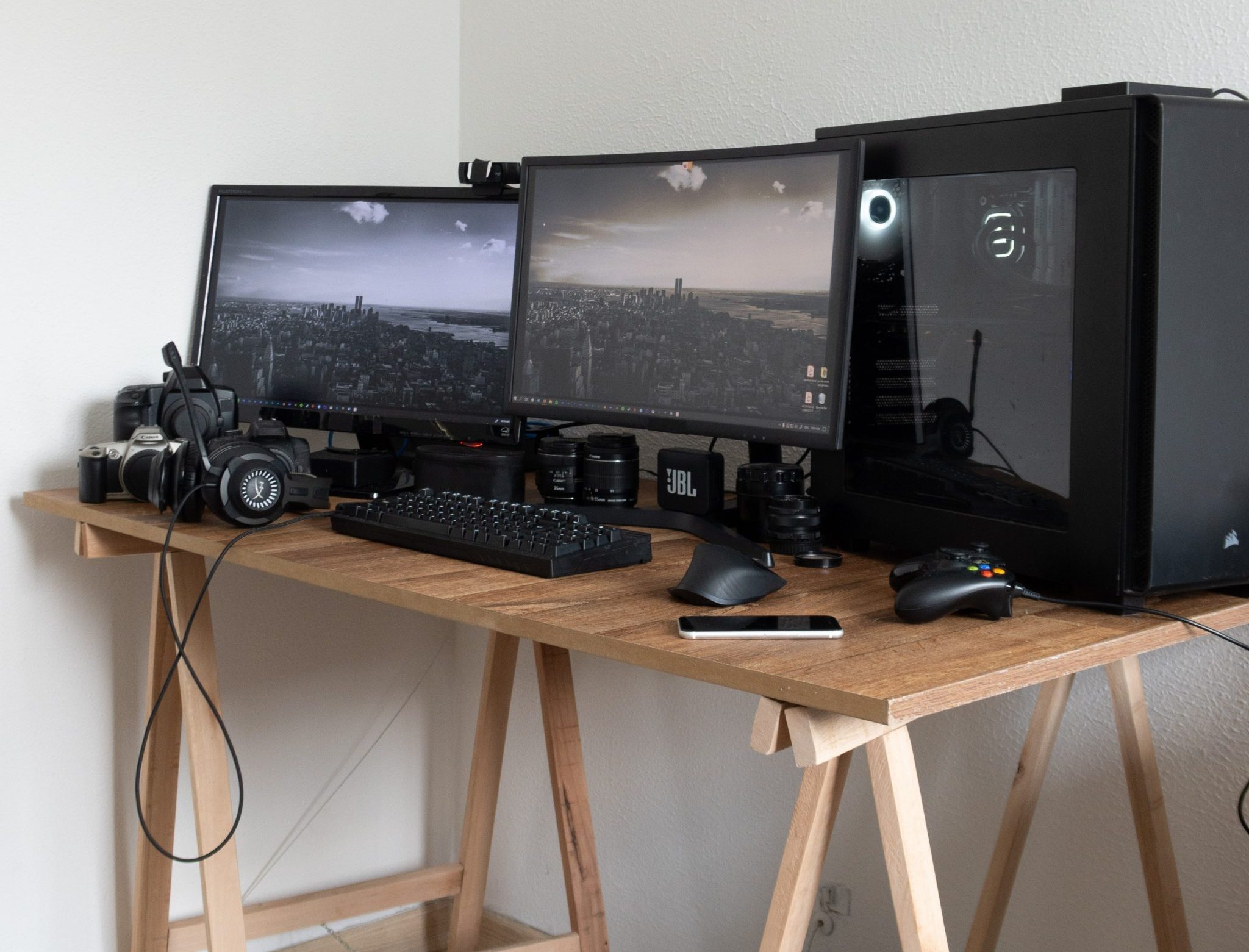 Desk with computer with two monitors and several pieces of equipment