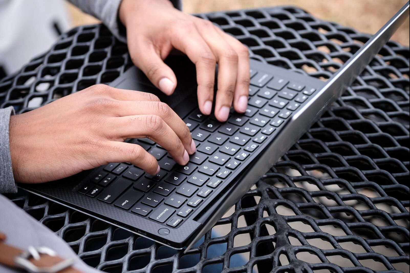 Hands typing on laptop