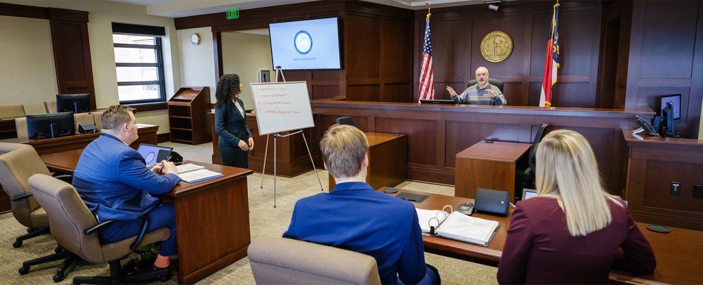 Members of the Wake Forest law school trial team practice for an upcoming tournament with feedback from law professor Ron Wright.