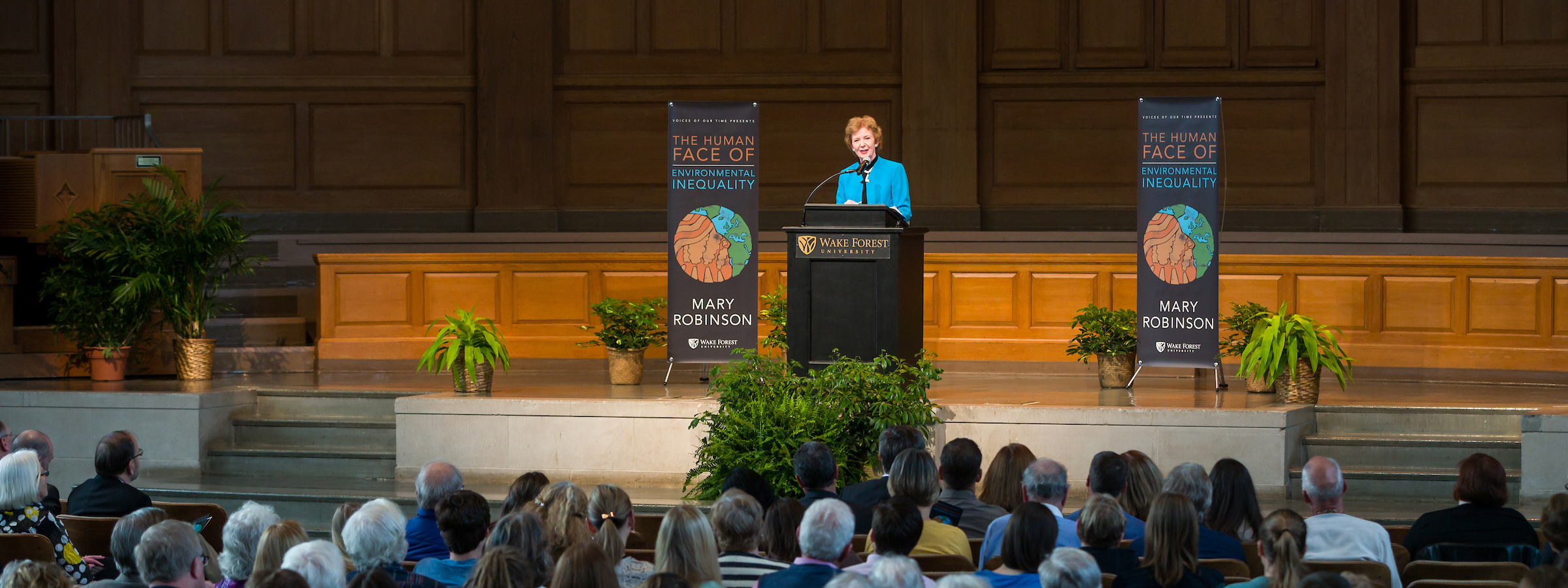 Mary Robinson stands at a podium on the stage of Wait Chapel in front of a seat crowd