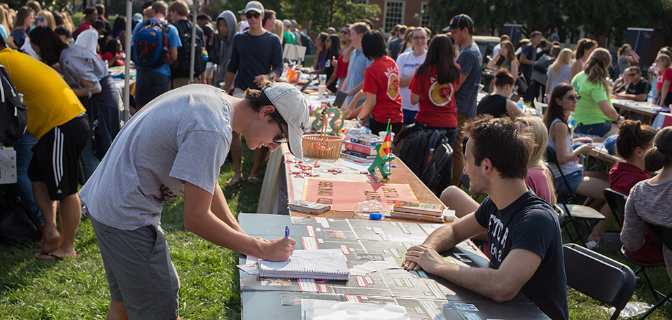 A student signs up to learn more about campus involvement the WFU Fall Student Involvement Fair