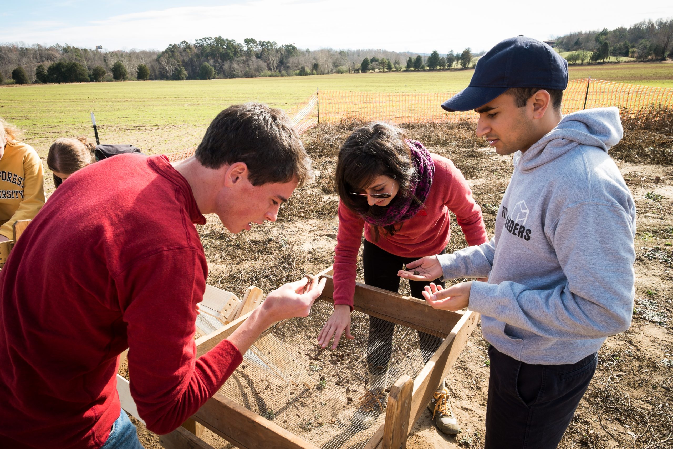 Wake Forest anthropology professor Eric Jones takes his North American prehistory class to dig at a research site on the Yadkin River on Saturday, November 23, 2013.  Peter Ellis ('14), Kimberly Paiz ('14), and Fahim Gulamali ('14) sift through the dirt looking for artifacts.