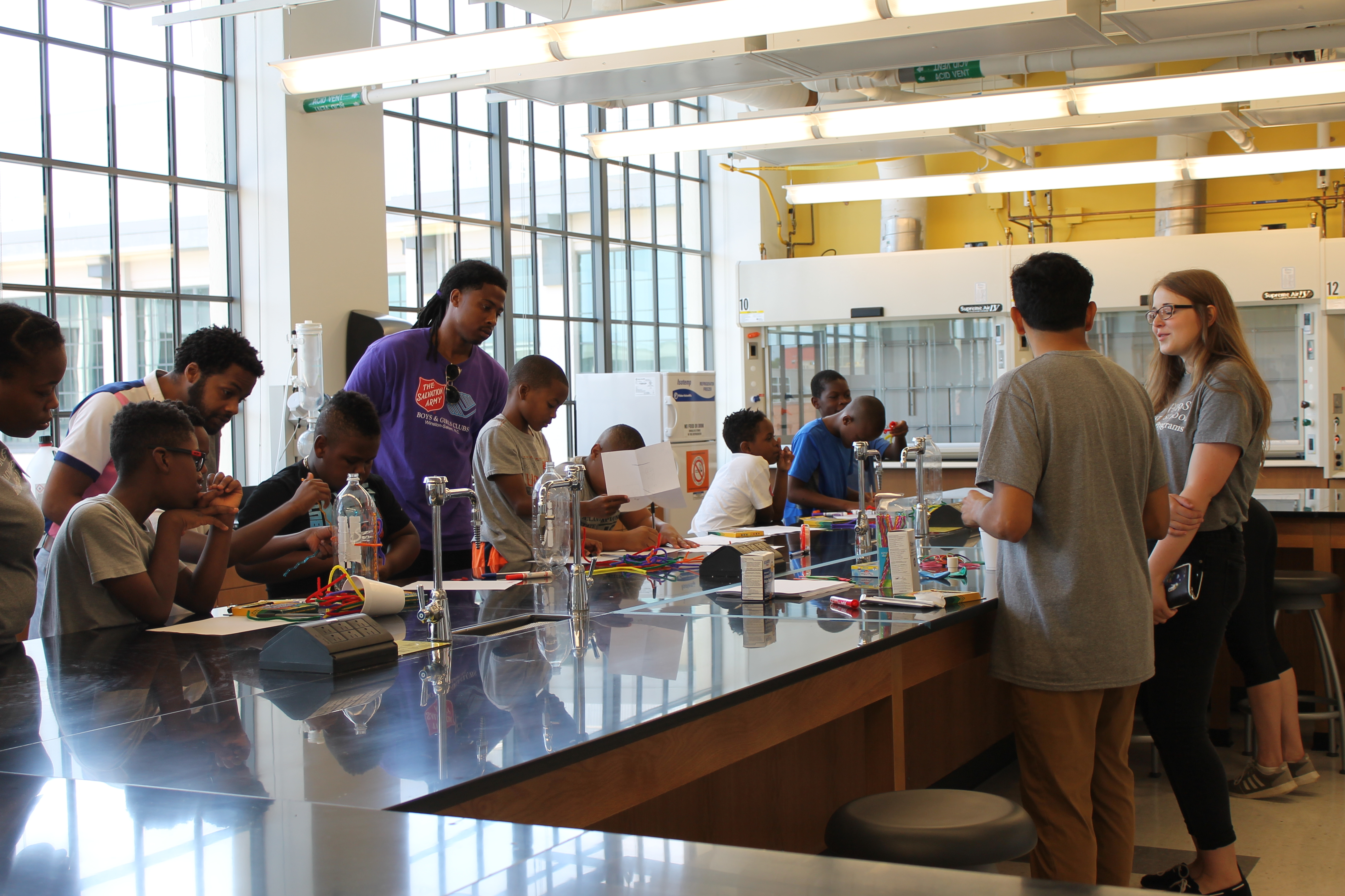 Sci Tech Summer Program. Israel Suarez teaches Boys from the Salvation Army Boys and Girls Club about rocket propulsion.