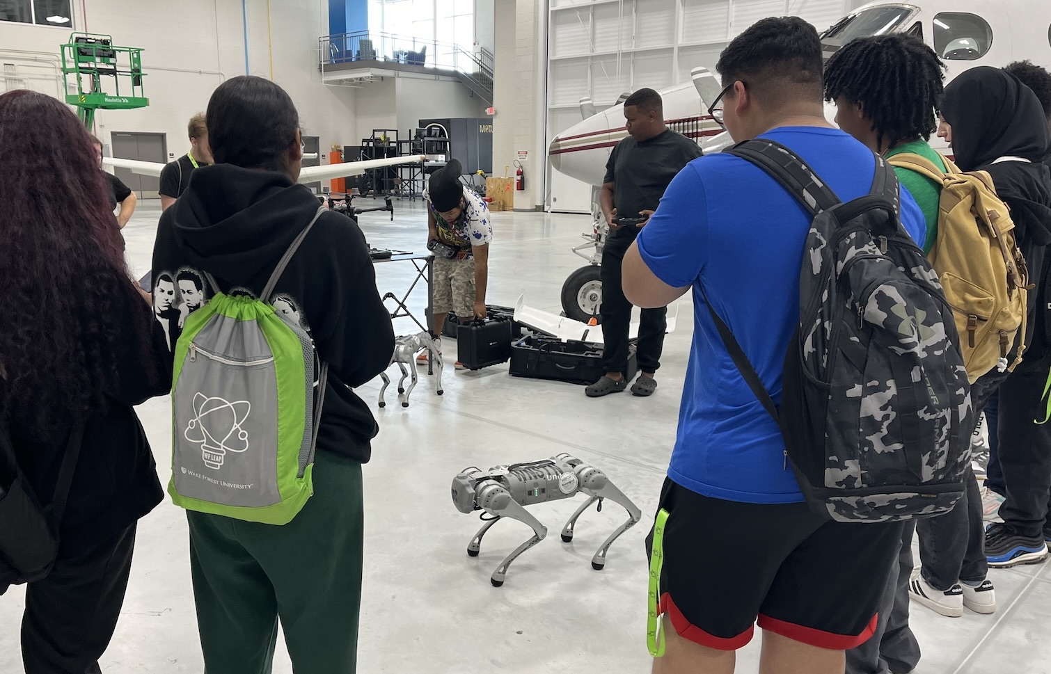 LEAP interns learning about robotic dogs and drones from the SweepWorx team during field trip to Forsyth Tech's Mazie S. Woodruff Aviation Tech Lab.