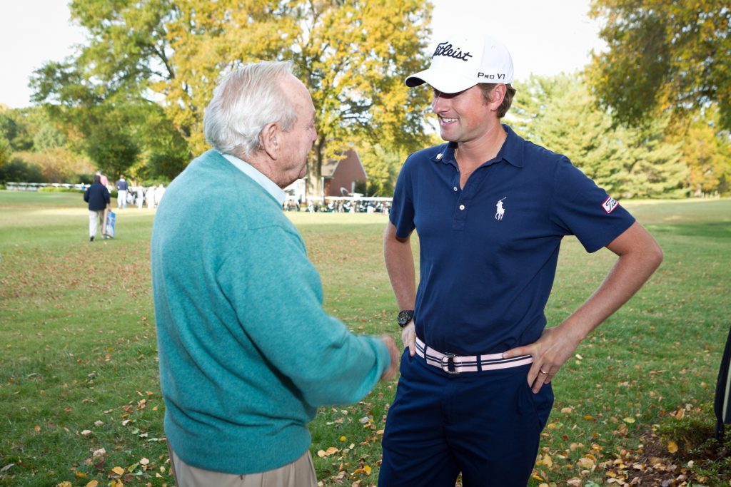 Palmer talks with PGA TOUR golfer Webb Simpson during Wake Forest’s Pro-Am golf tournament in 2011.