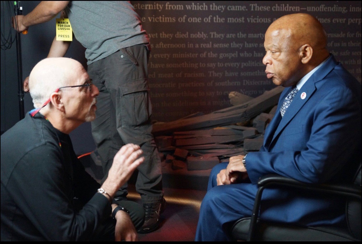 Peter Gilbert filming with Congressman John Lewis at the March for Our Lives Rally. 