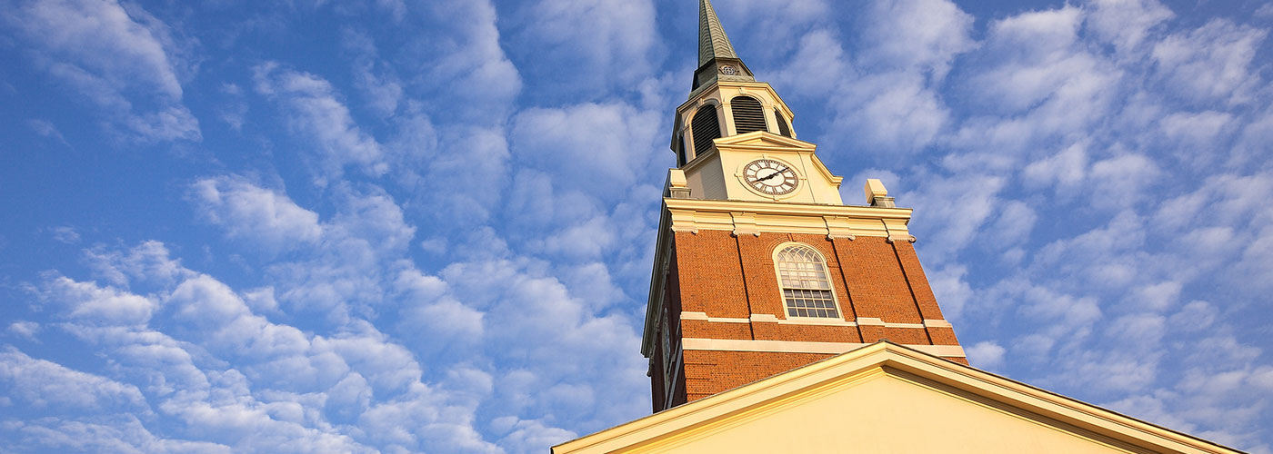 Photo of Wait Chapel's steeple with blue sky in the background. 