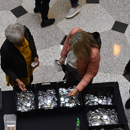 A parent and a student browse giveaway items at the registration area in Benson University Center during Family Weekend