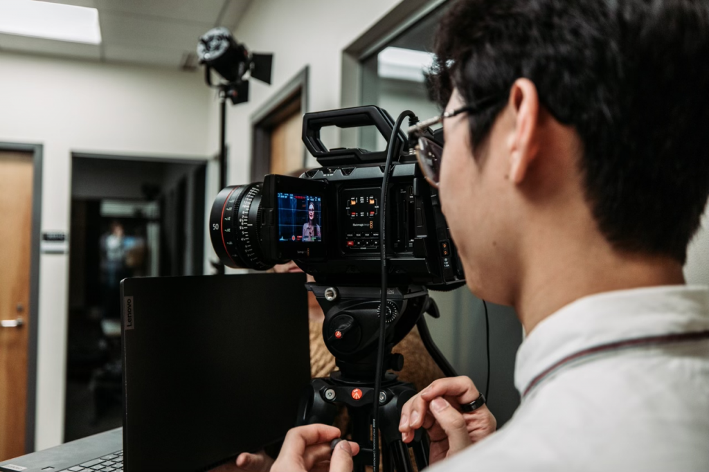 Student working a video camera