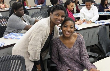 Student and instructor smiling at the camera during a College LAUNCH session.